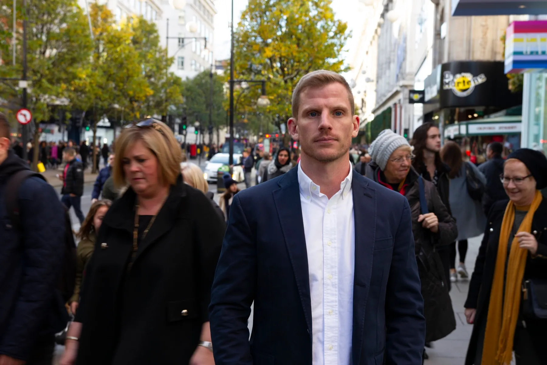 Ed in a suit on a city street